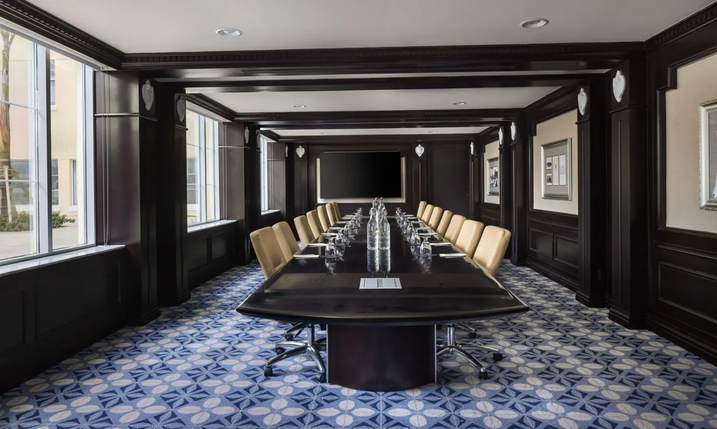 Boardroom with a long conference table and tan chairs at British Colonial Nassau.