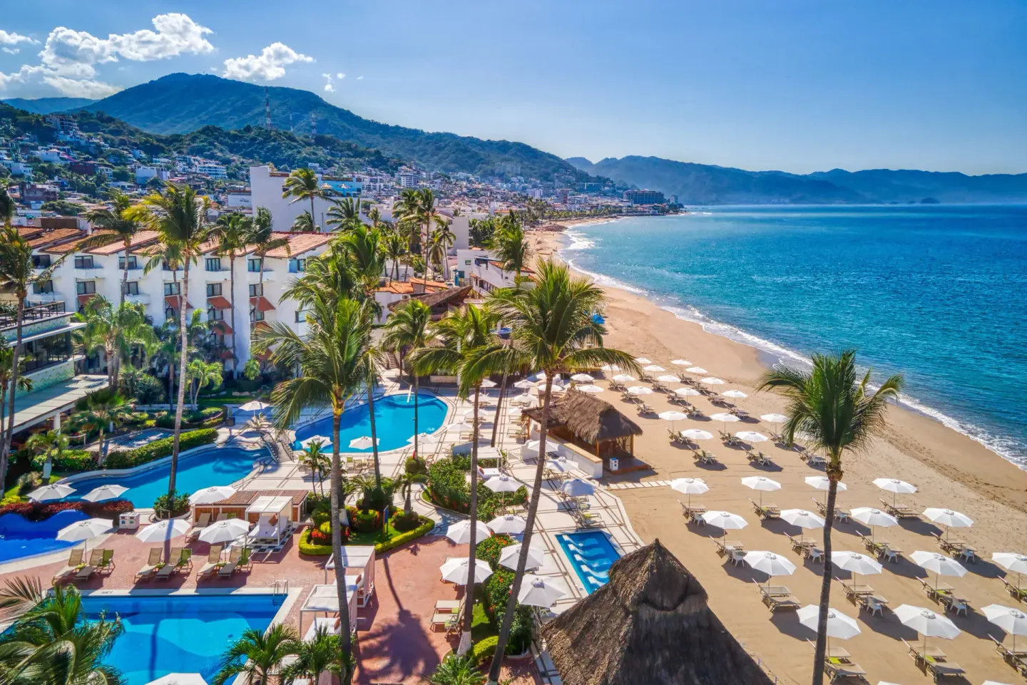 Aerial resort view at Buenaventura Grand Hotel & Great Moments with pools, palms, beach, and bay.