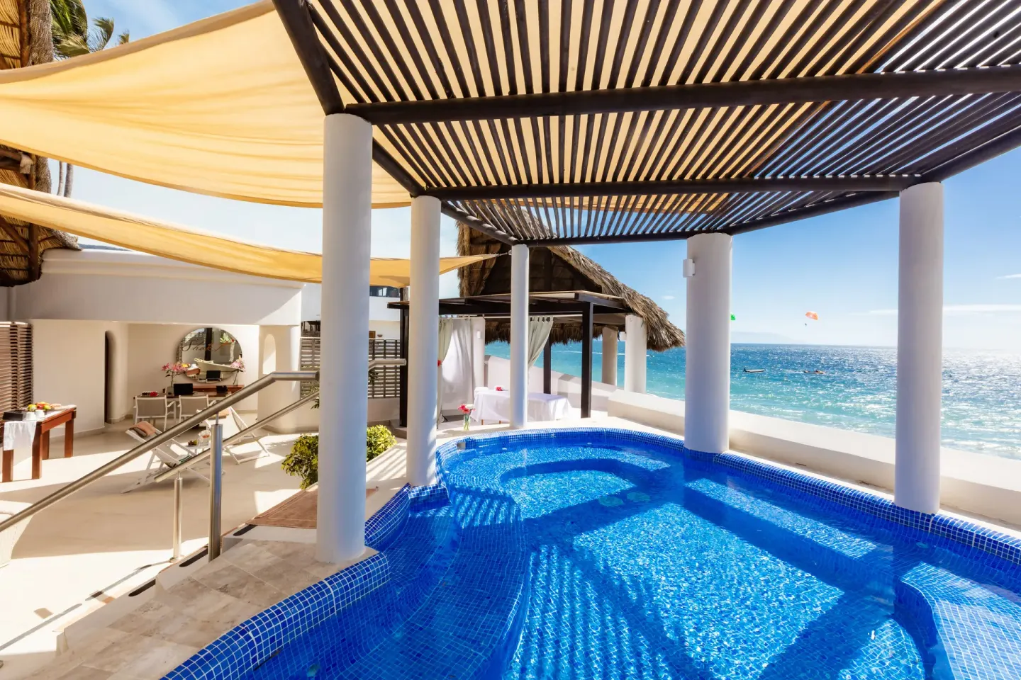 Blue spa plunge pool under a slatted pergola at Buenaventura Grand Hotel & Great Moments.