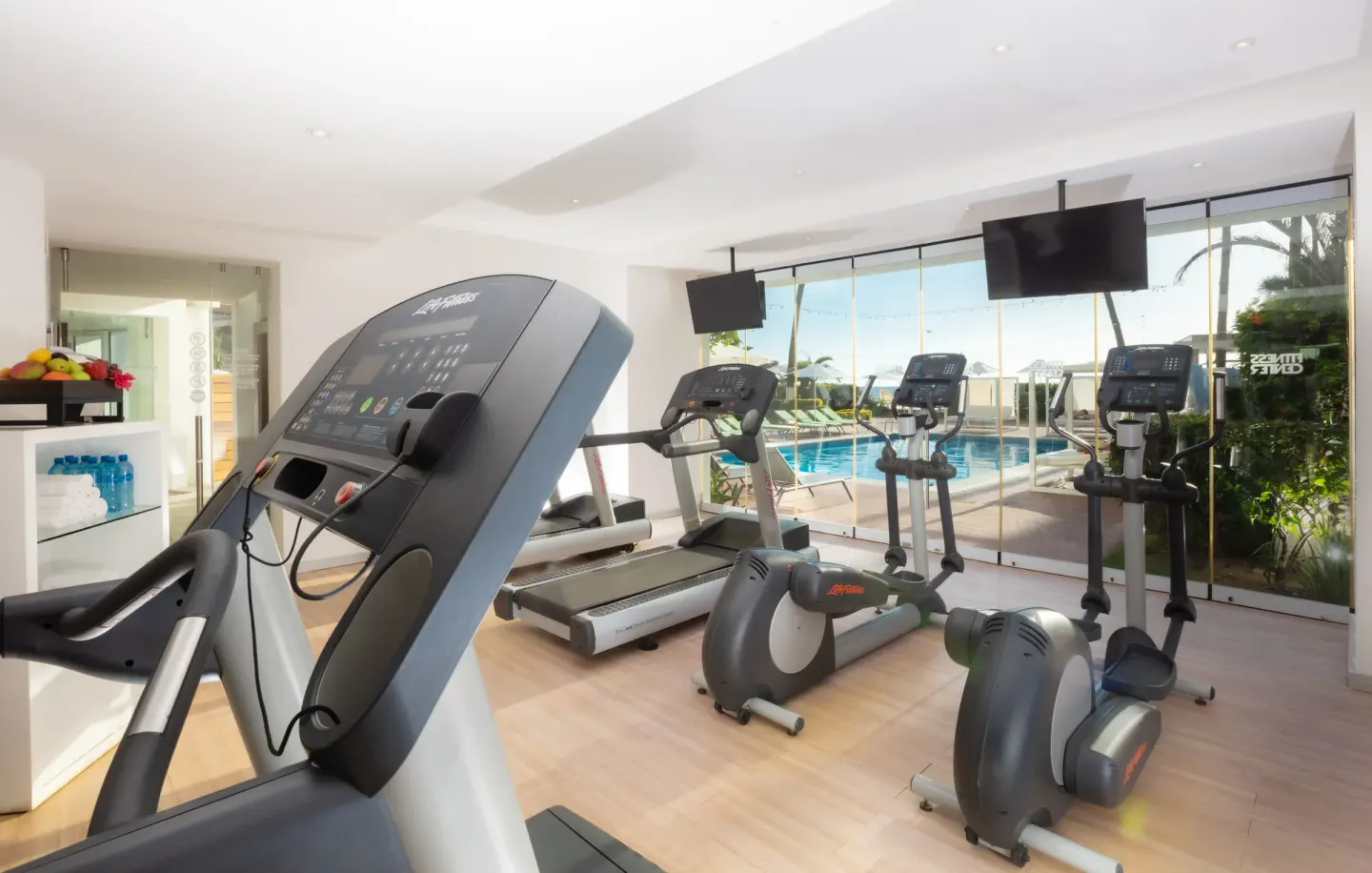 Cardio machines overlooking the pool at Buenaventura Grand Hotel & Great Moments.