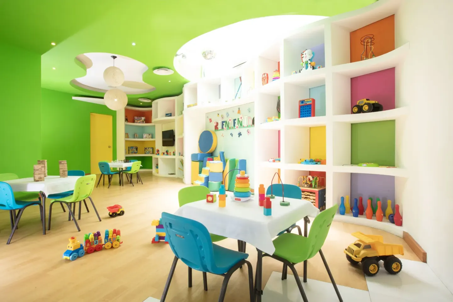 Kids club activity tables with toys and colorful shelves at Buenaventura Grand Hotel & Great Moments.