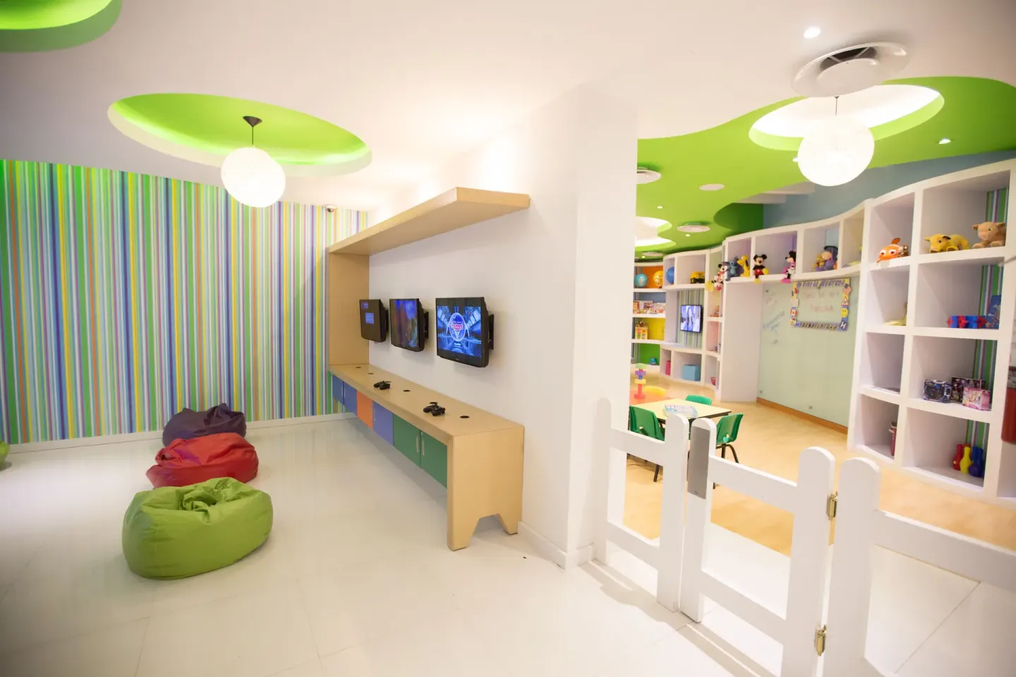 Kids club media area with beanbags beside a gated playroom at Buenaventura Grand Hotel & Great Moments.