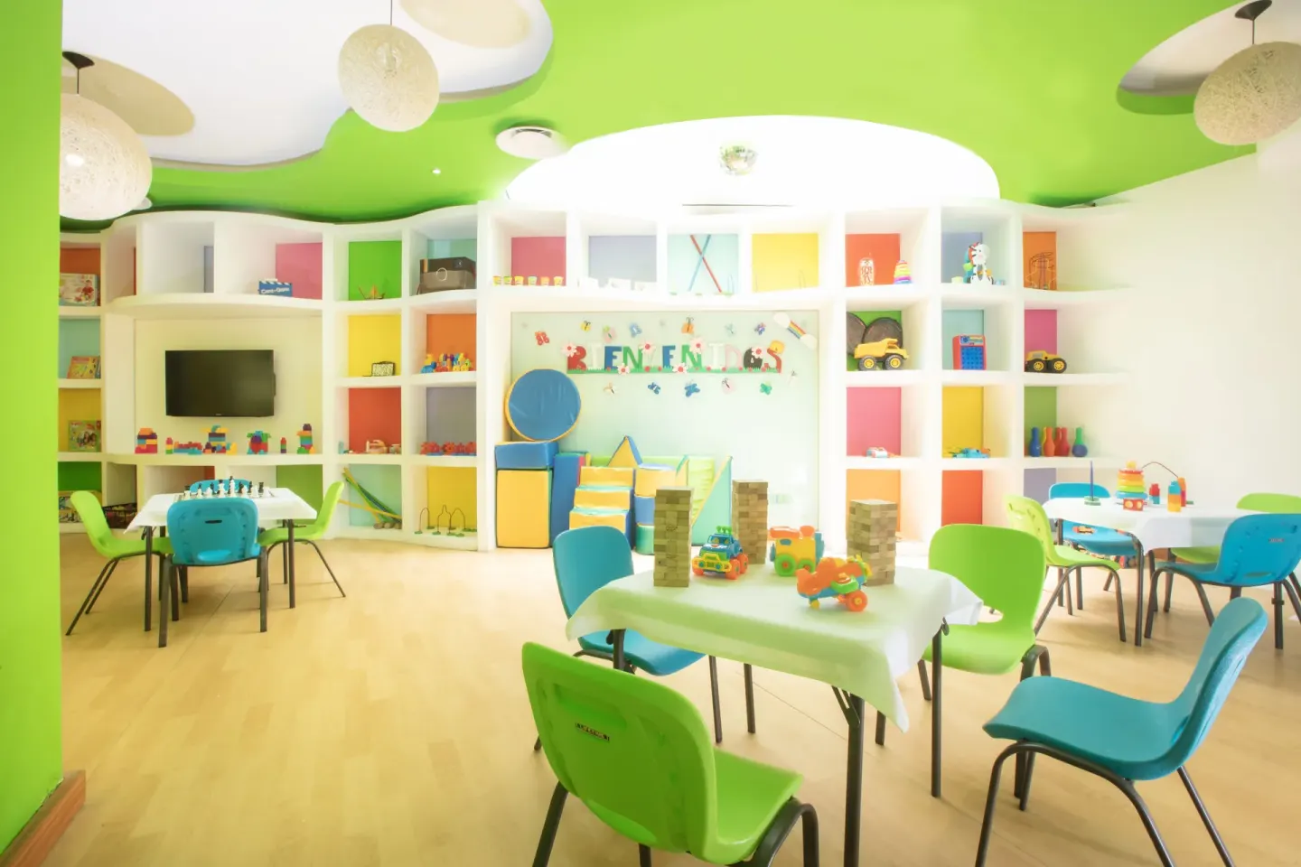 Bright kids club playroom with toys, tables, and TV at Buenaventura Grand Hotel & Great Moments.