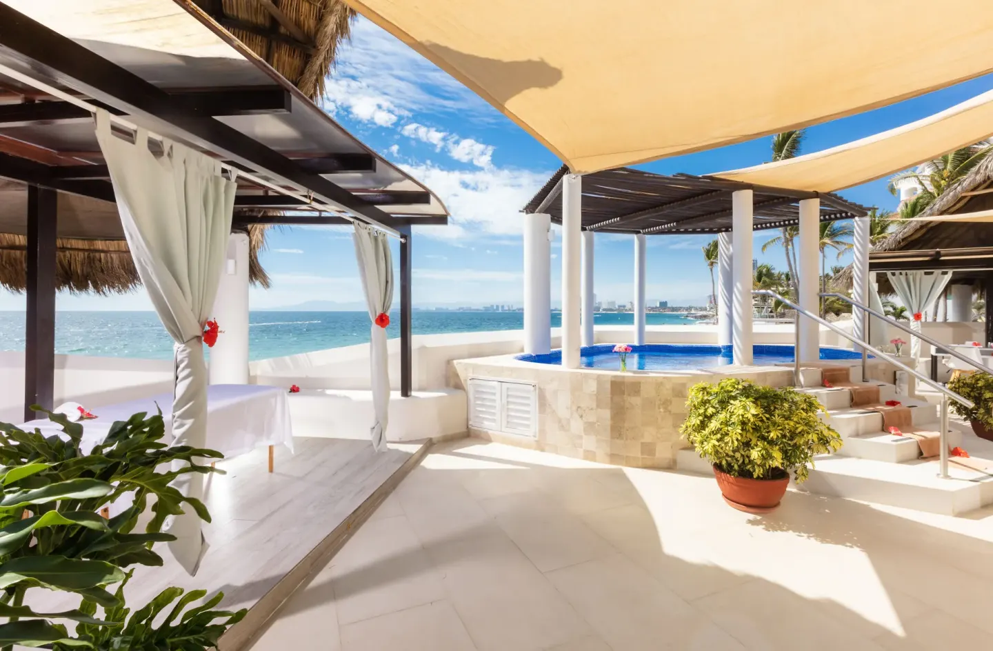 Oceanfront spa terrace with cabanas and blue plunge pool at Buenaventura Grand Hotel & Great Moments.