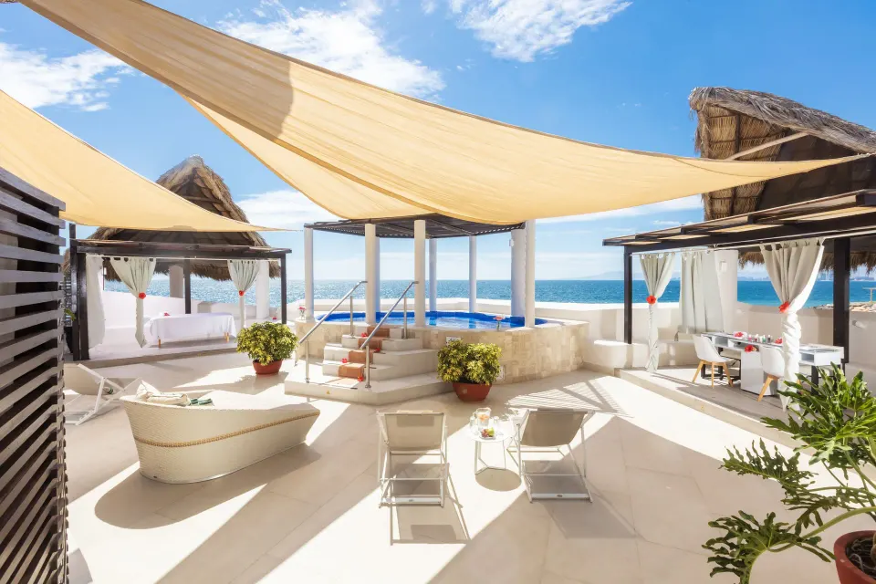 Spa terrace with shade sails, loungers, cabanas, and ocean view at Buenaventura Grand Hotel & Great Moments.