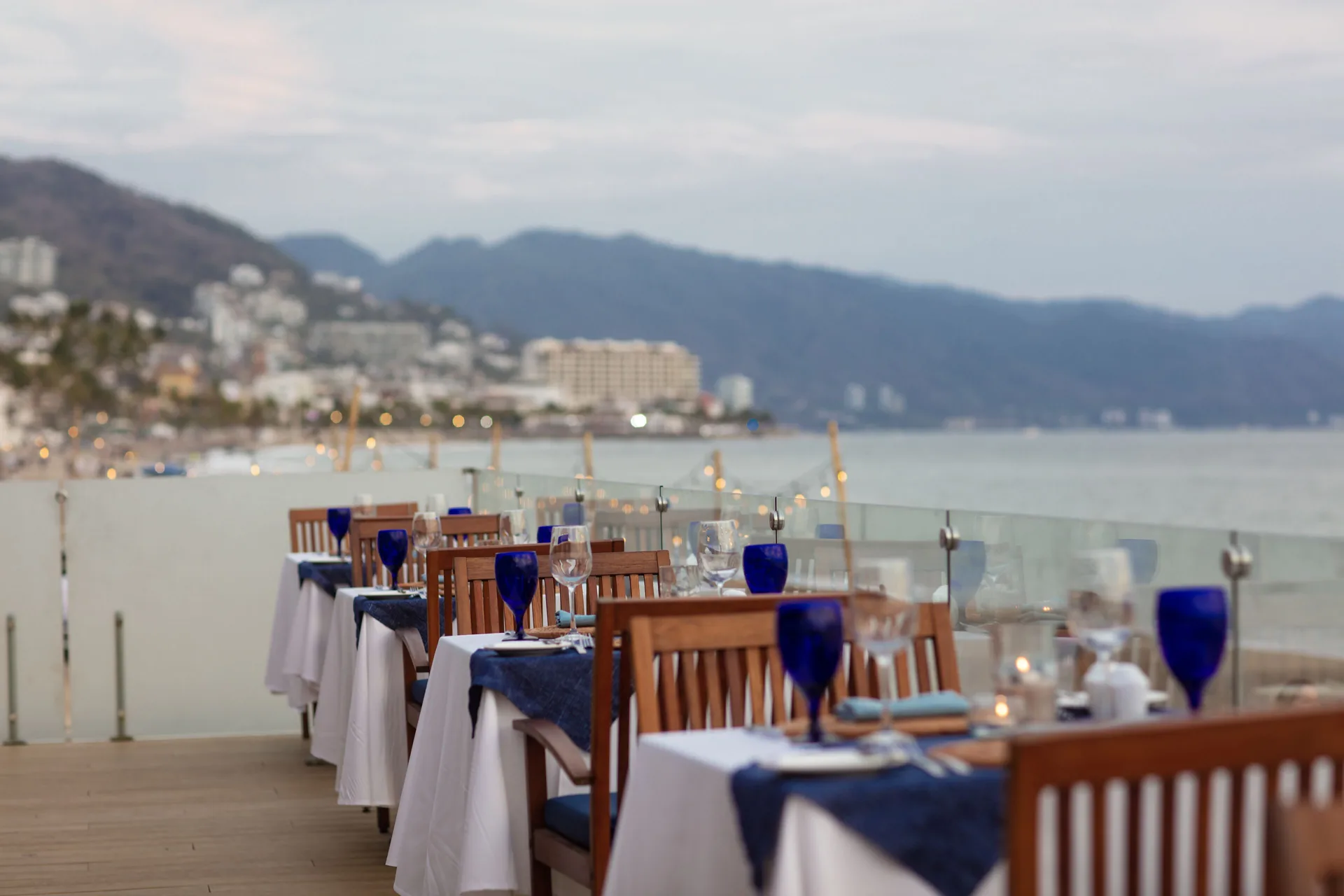 Oceanfront dining tables at dusk at Buenaventura Grand Hotel & Great Moments.