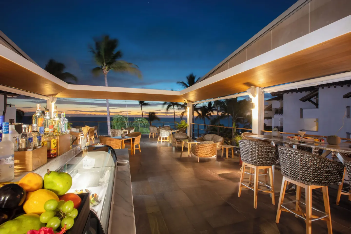 Open-air rooftop bar at twilight at Buenaventura Grand Hotel & Great Moments.