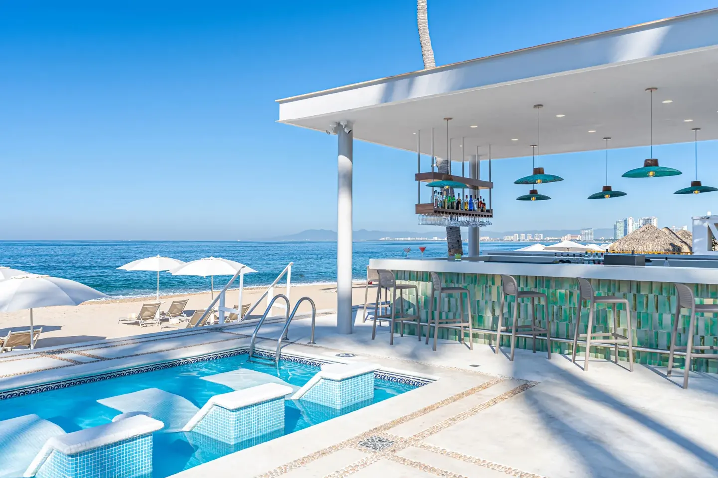 Poolside beach bar at Buenaventura Grand Hotel & Great Moments beside loungers and the ocean.