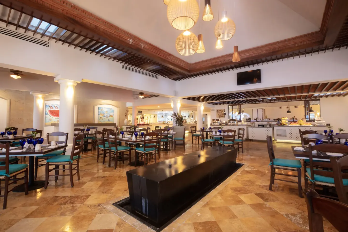 Restaurant dining room with turquoise chairs at Buenaventura Grand Hotel & Great Moments.
