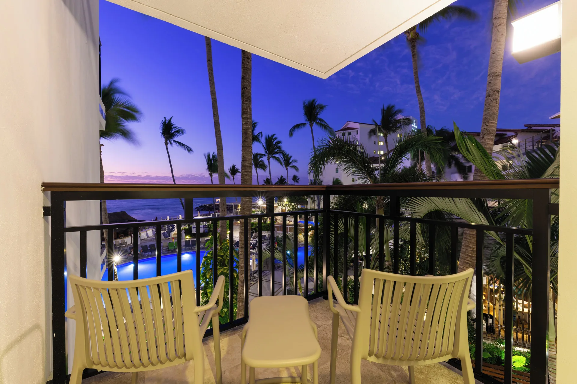 Deluxe Two Suite at Buenaventura Grand Hotel with ocean view balcony, modern seating area, and spacious layout for groups in Puerto Vallarta.