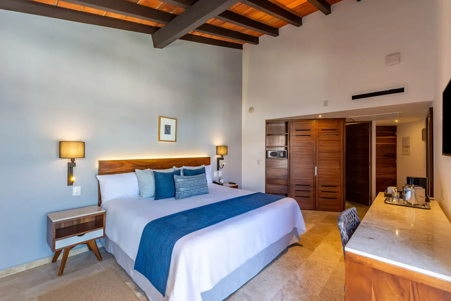 Deluxe Ocean View king bed and desk at Buenaventura Grand Hotel & Great Moments.