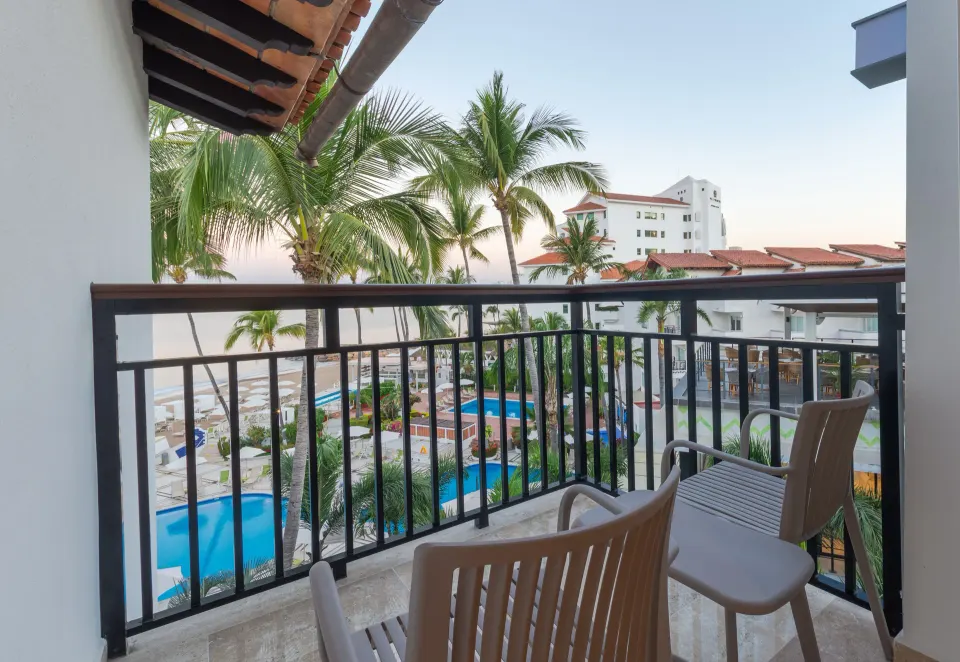 Deluxe Ocean View balcony with chairs at Buenaventura Grand Hotel & Great Moments.