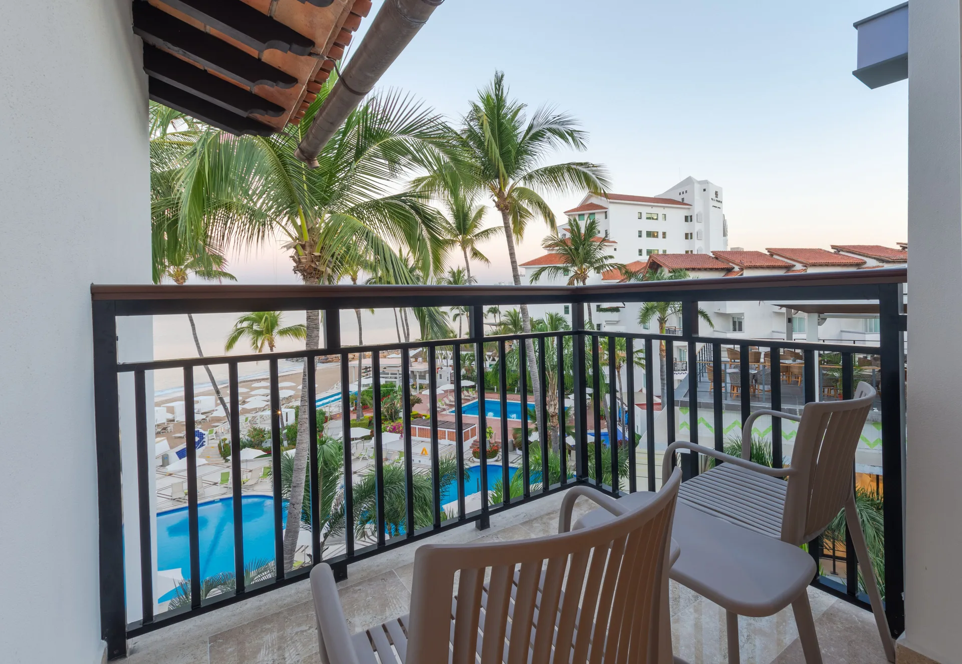 Family Deluxe Room at Buenaventura Grand Hotel with two beds, balcony seating, and family-friendly amenities in Puerto Vallarta's Hotel Zone.