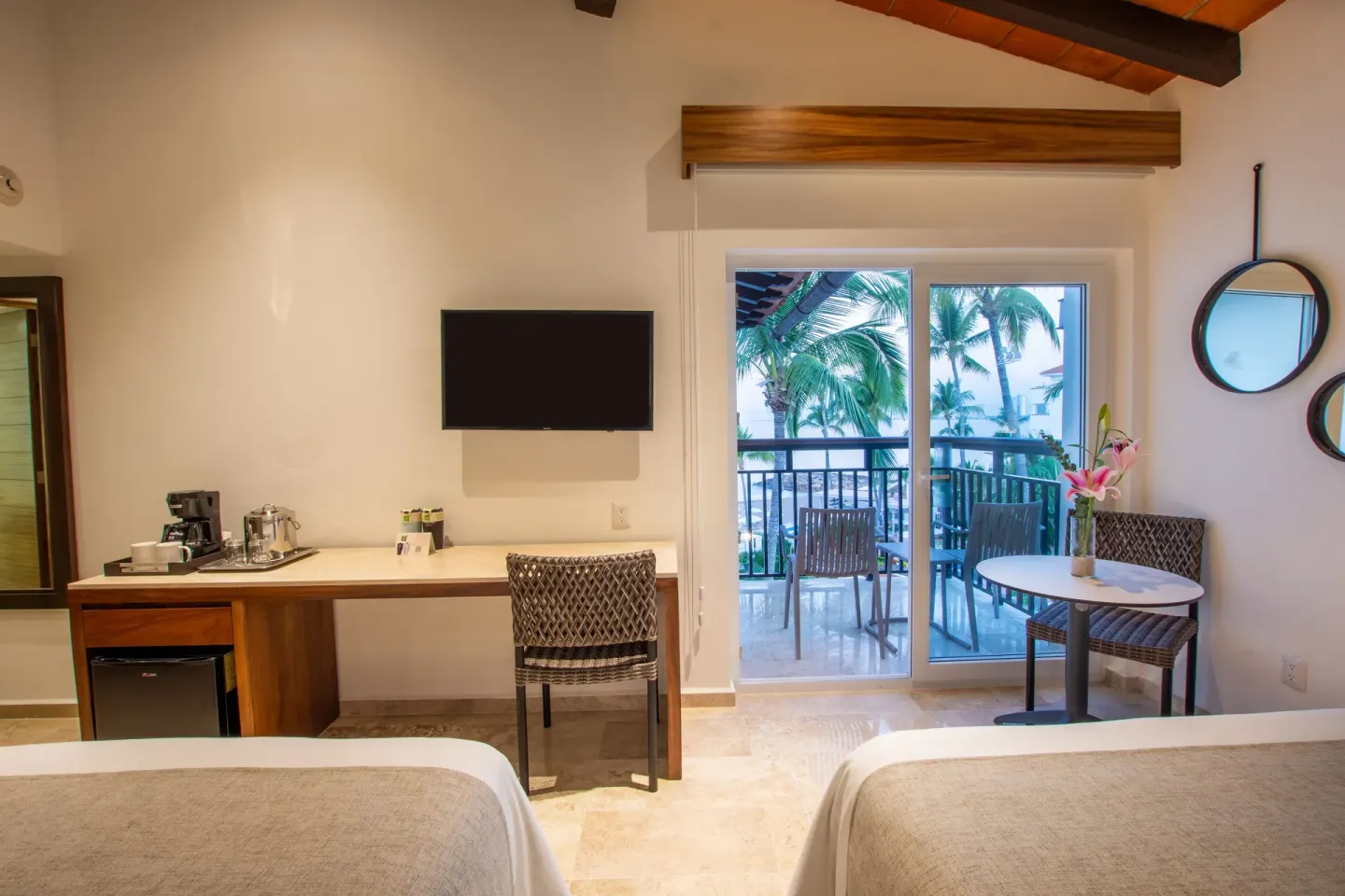 Deluxe Ocean View two-bed room desk and balcony at Buenaventura Grand Hotel & Great Moments.