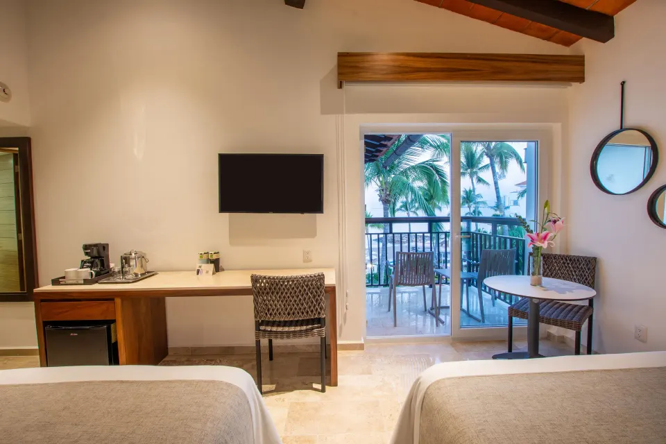 Deluxe Ocean View two-bed room desk and balcony at Buenaventura Grand Hotel & Great Moments.