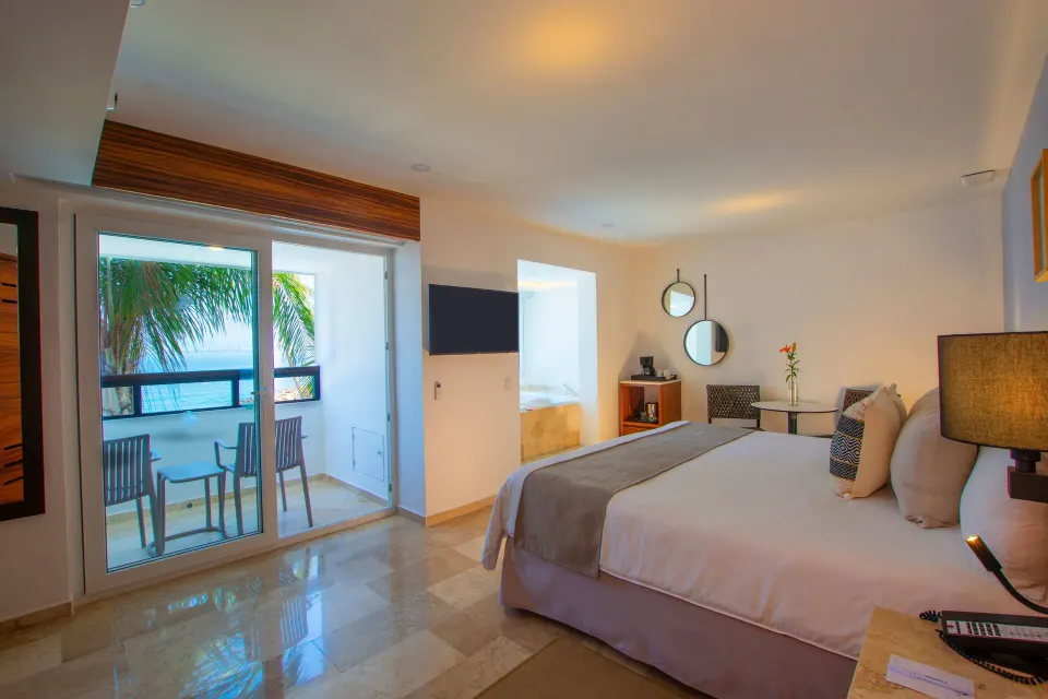 Honeymoon Suite king bed and balcony at Buenaventura Grand Hotel & Great Moments.