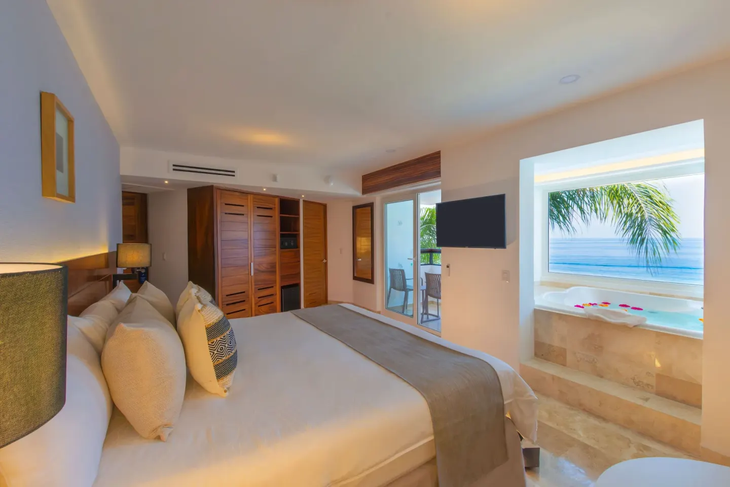 Honeymoon Suite king bed and ocean-view tub at Buenaventura Grand Hotel & Great Moments.
