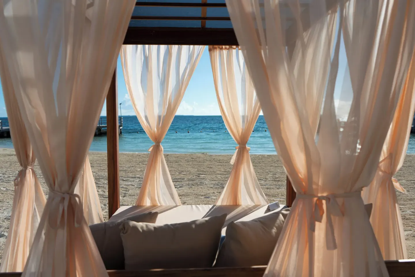 Beach cabana with sheer curtains facing the ocean at Cancun Bay Hotel.