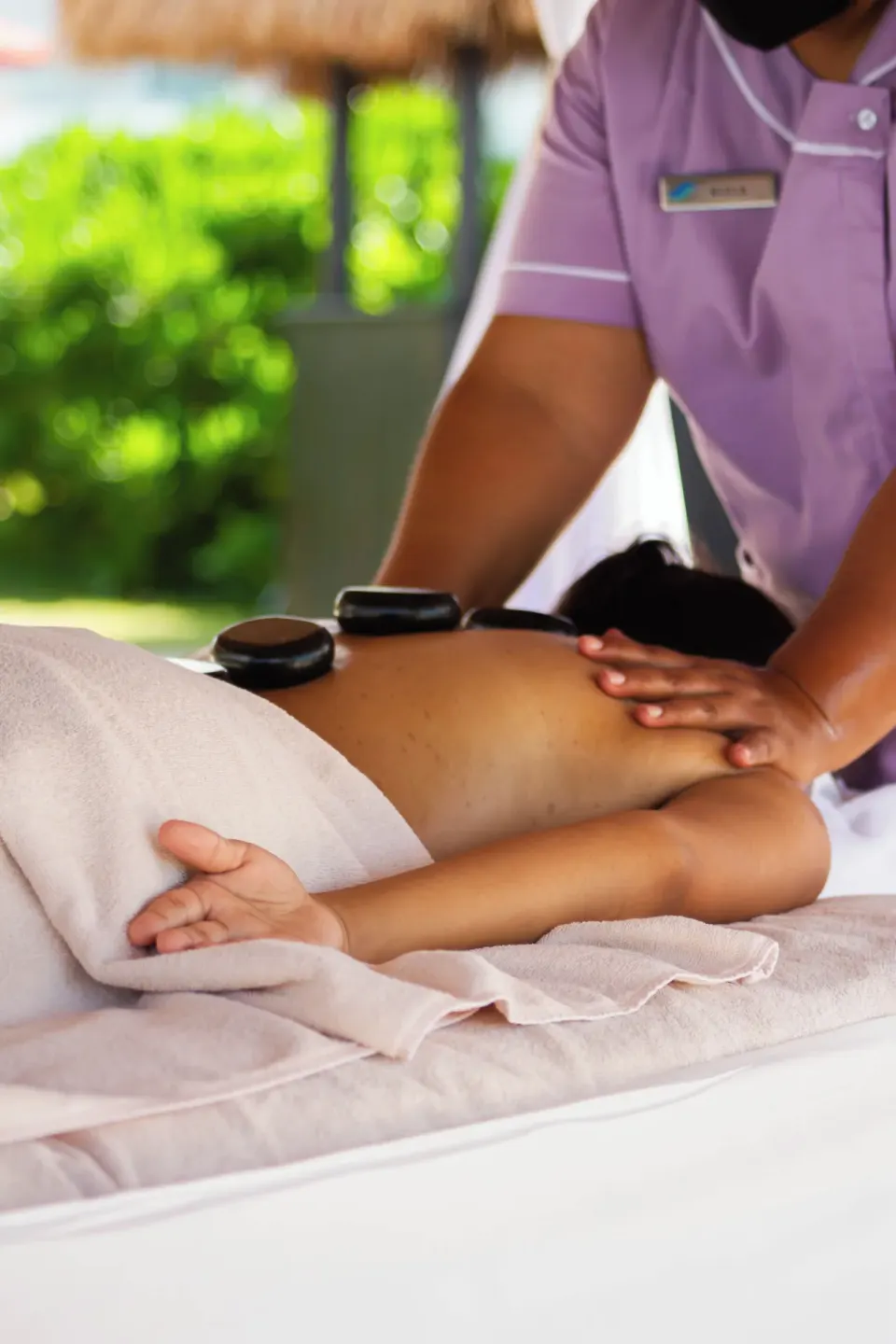 Hot stone massage treatment on a spa table at Cancun Bay Hotel.