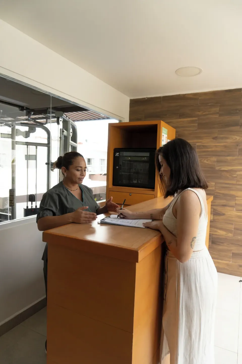 Guest fills out a form at the spa reception counter at Cancun Bay Hotel.