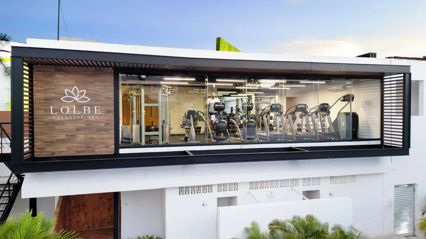 Glass-fronted fitness center with spa sign above the courtyard at Cancun Bay Hotel.