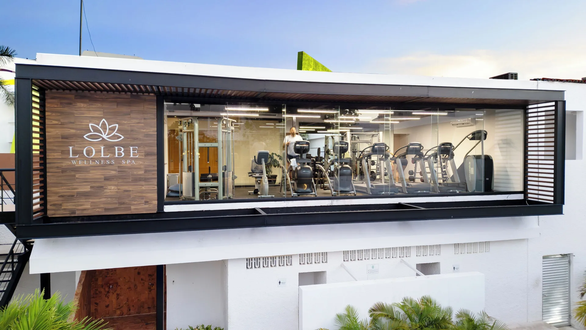 Glass-fronted fitness center with spa sign above the courtyard at Cancun Bay Hotel.