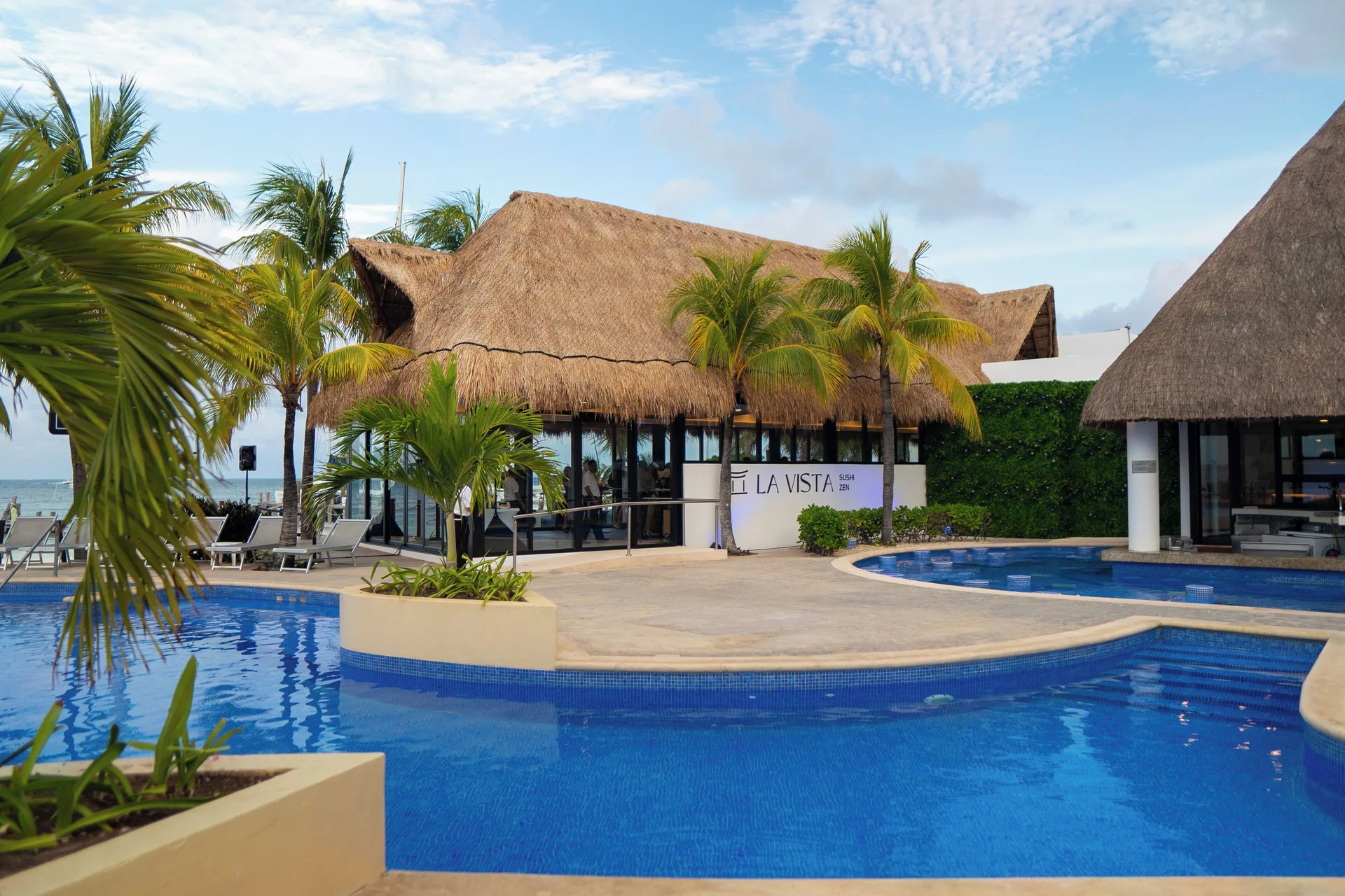 La Vista Sushi Zen by the pool with thatched roofs at Cancun Bay Hotel.