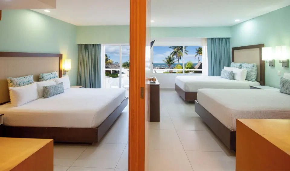 Junior Suite with two bedrooms and ocean-facing windows at Cancun Bay Hotel.