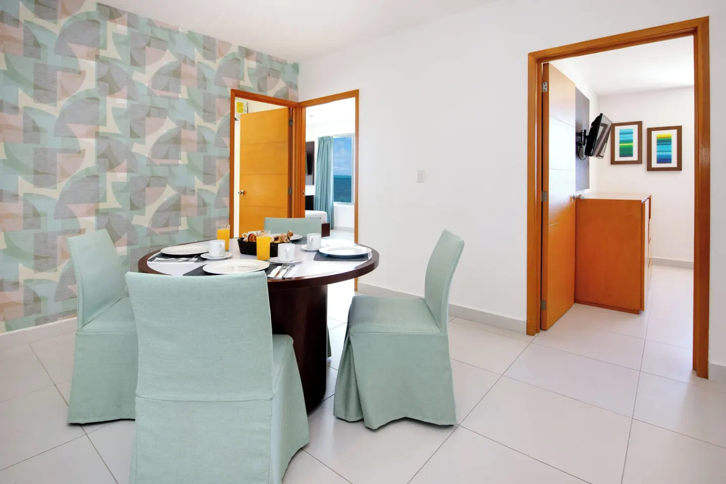 Master Suite 3 Bedrooms dining area with round table and adjoining bedrooms at Cancun Bay Hotel.