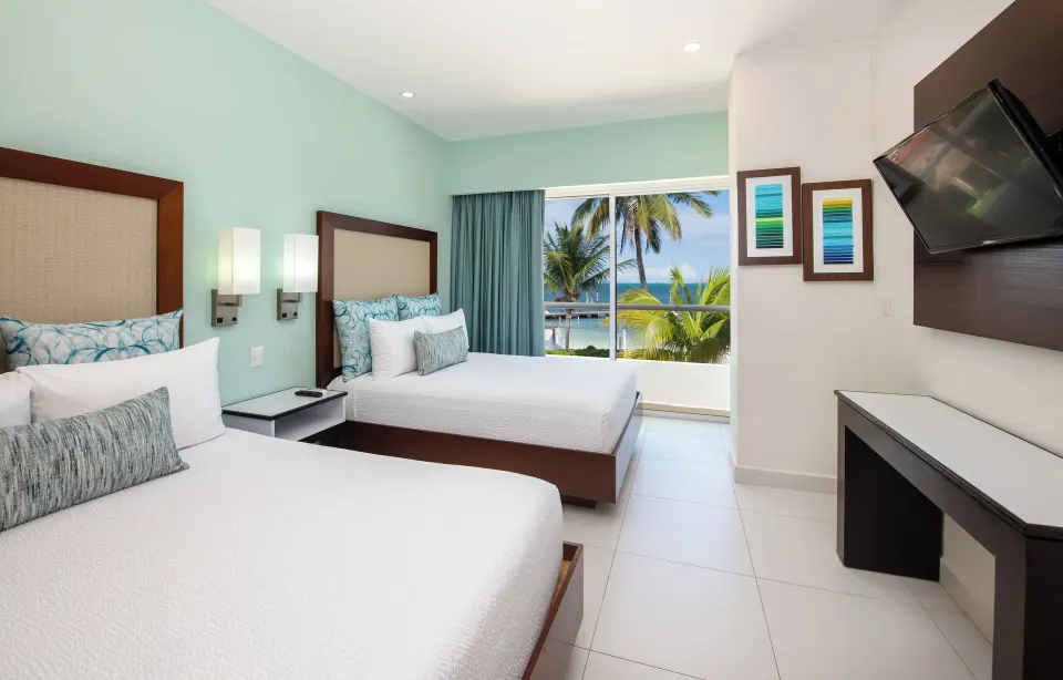 Superior Ocean View room with two beds and balcony view at Cancun Bay Hotel.