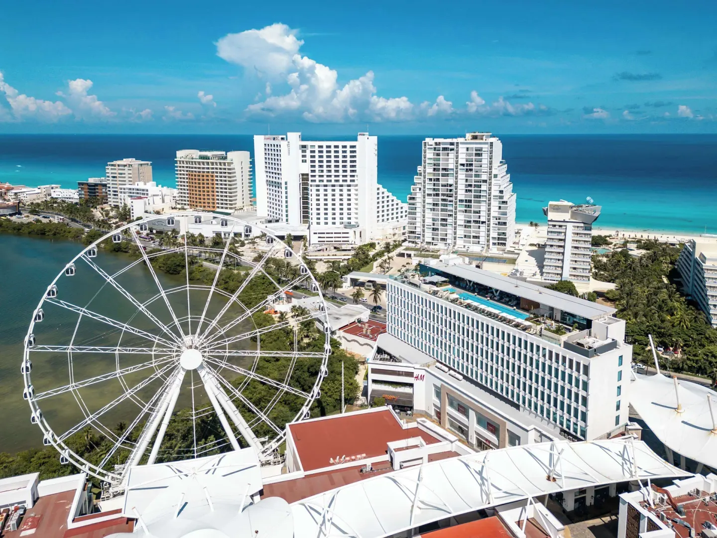Aerial view of Canopy by Hilton Cancun La Isla, Ferris wheel, lagoon, and beach.
