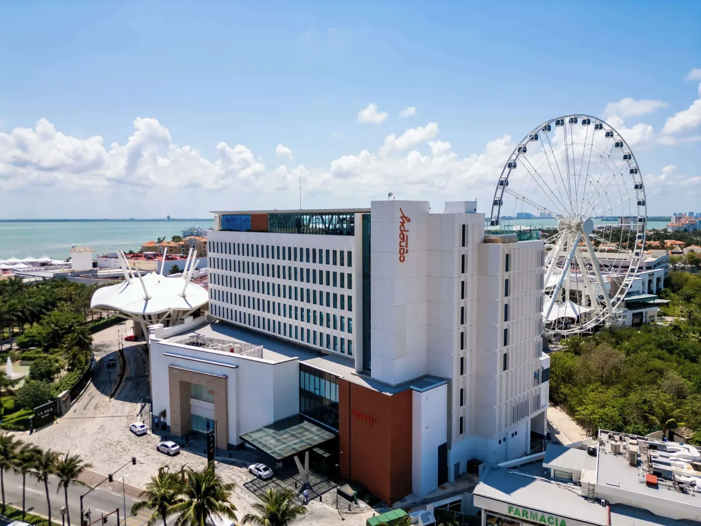Canopy by Hilton Cancun La Isla exterior beside lagoon and Ferris wheel.