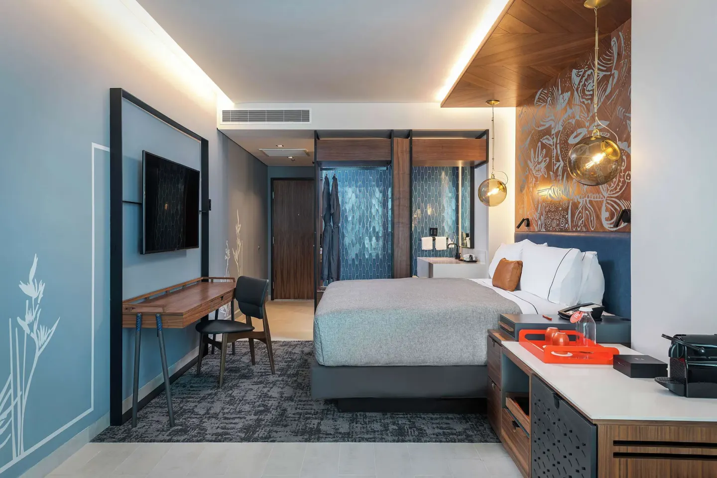 King guest room with desk, media wall and open bathroom area at Canopy by Hilton Cancun La Isla.