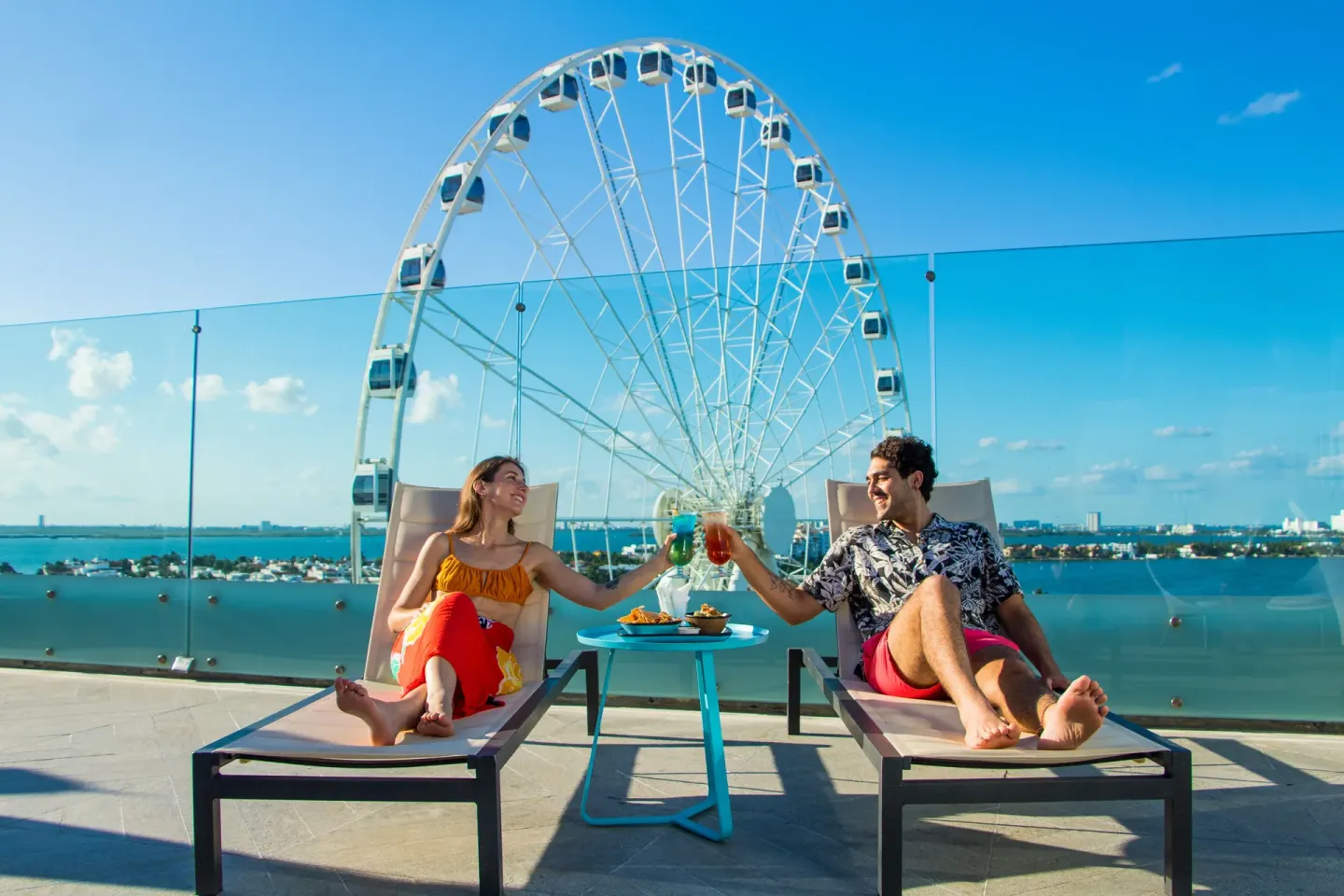 Guests toast drinks on rooftop loungers at Canopy by Hilton Cancun La Isla.