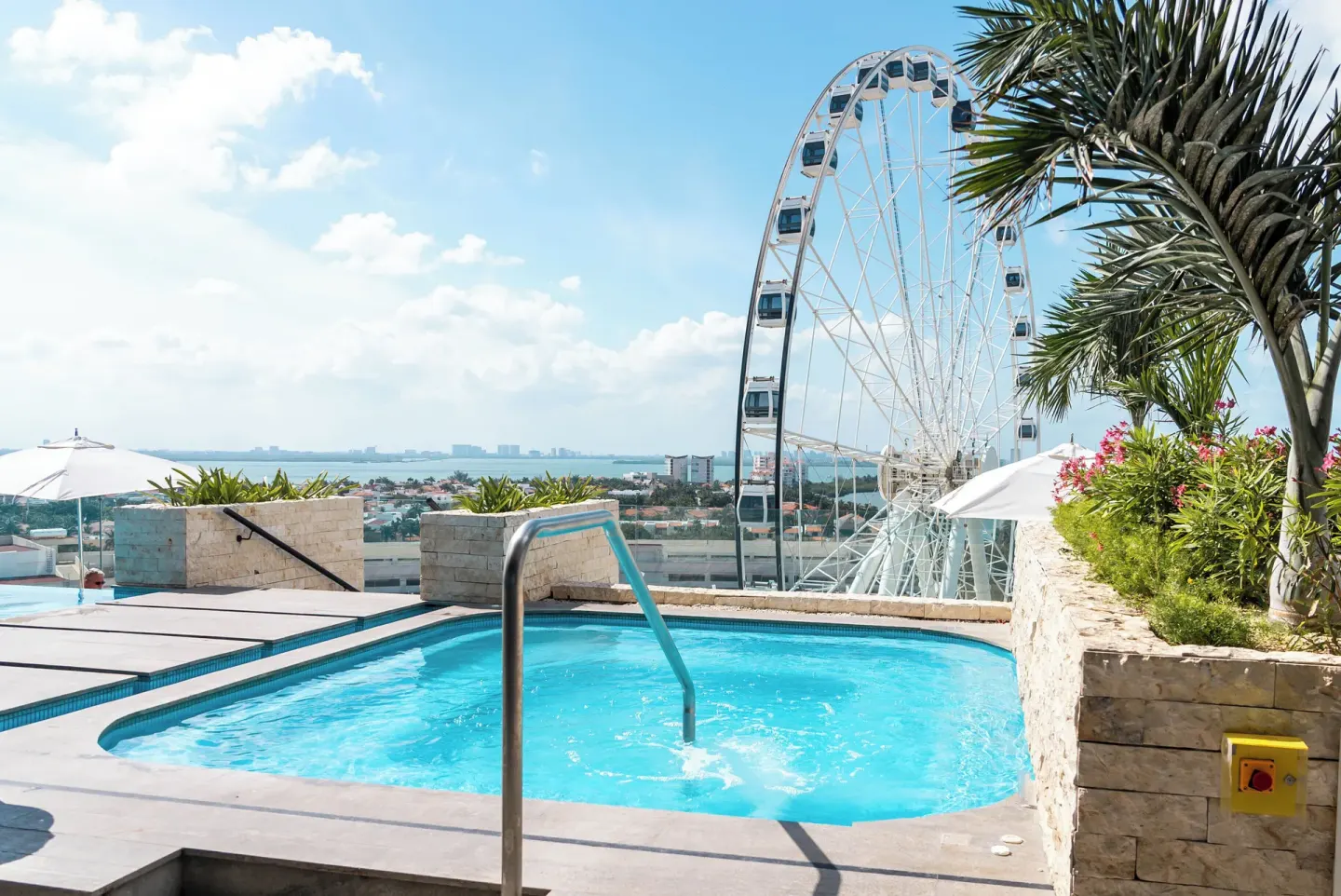 Rooftop pool with Ferris wheel view at Canopy by Hilton Cancun La Isla.