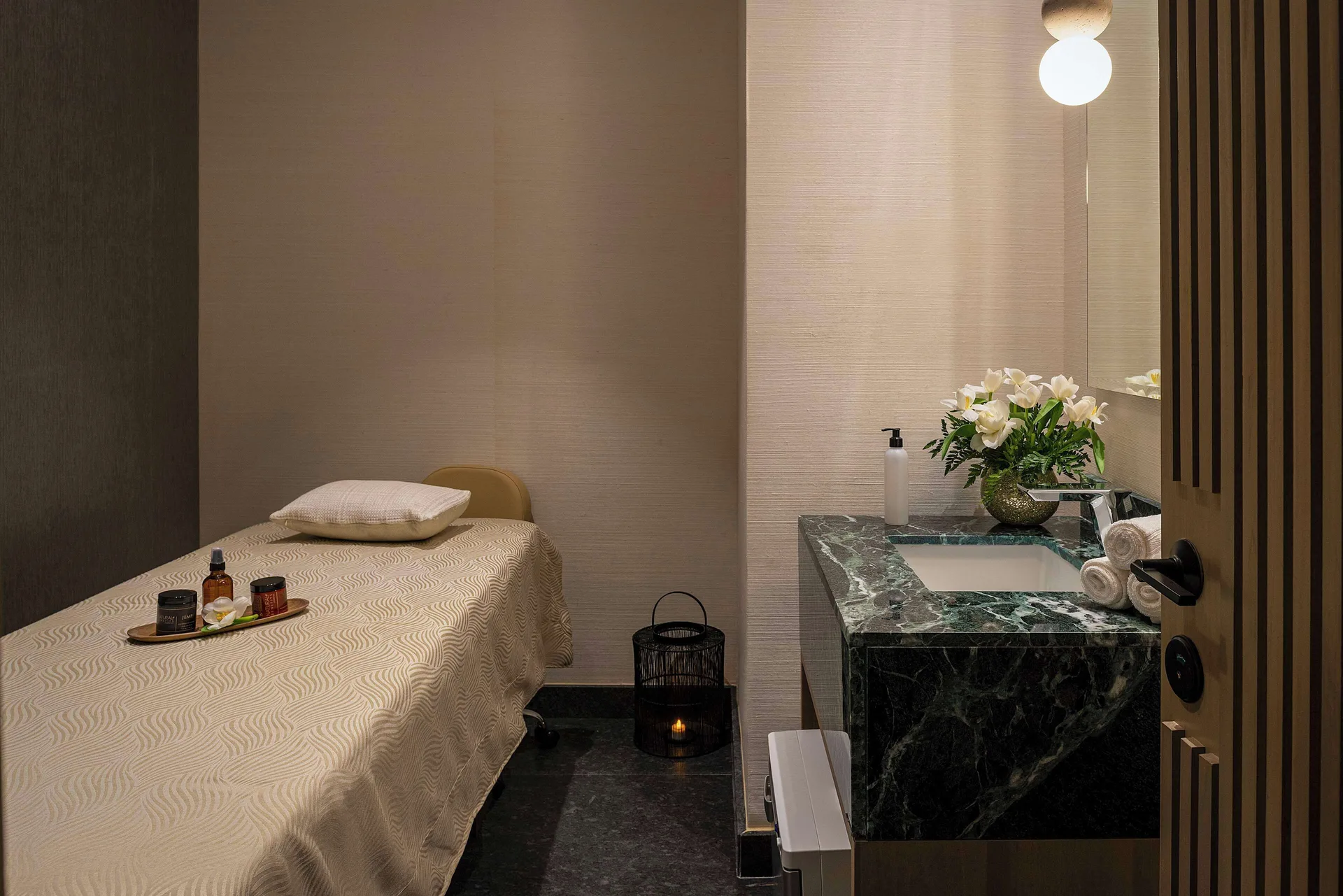 Single spa treatment room with massage table and vanity at Canopy by Hilton Cancun La Isla.