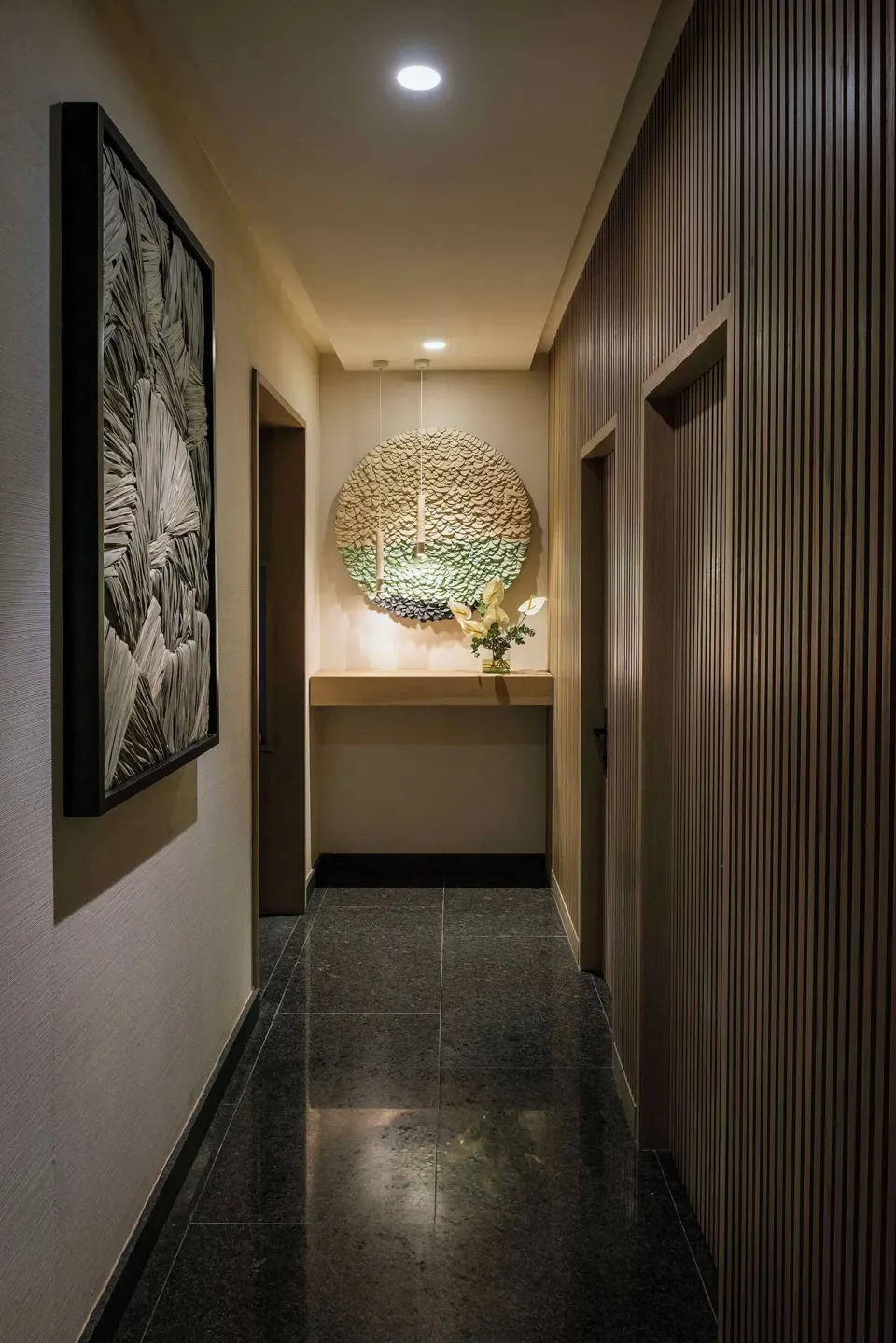 Spa corridor with wall art and textured decor at Canopy by Hilton Cancun La Isla.