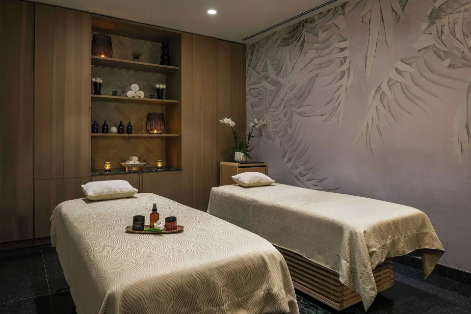 Spa treatment room with two massage tables at Canopy by Hilton Cancun La Isla.