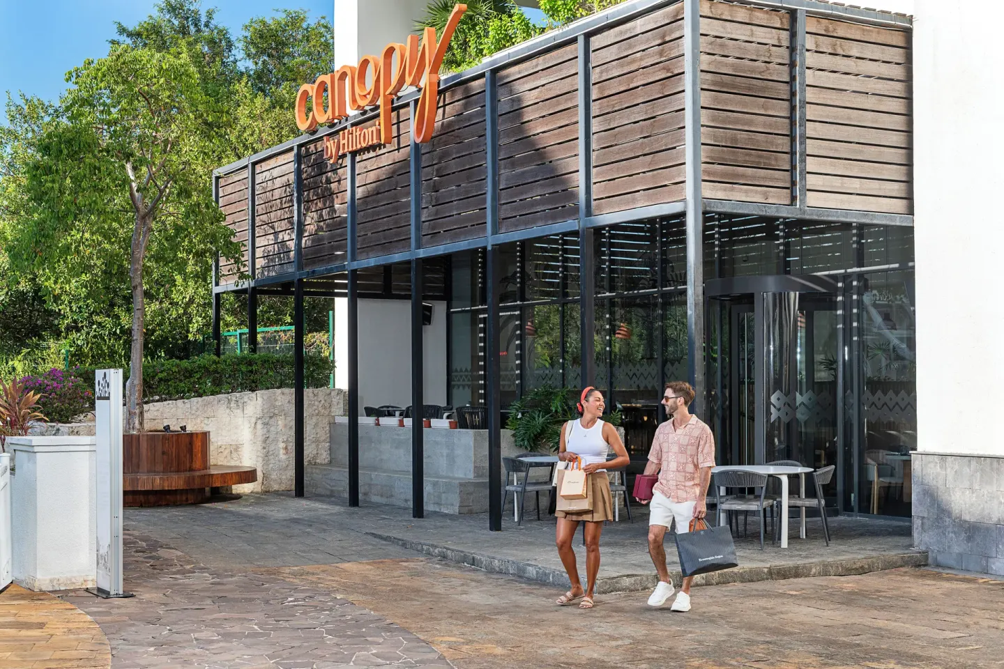 Street entrance and patio seating at Canopy by Hilton Cancun La Isla.