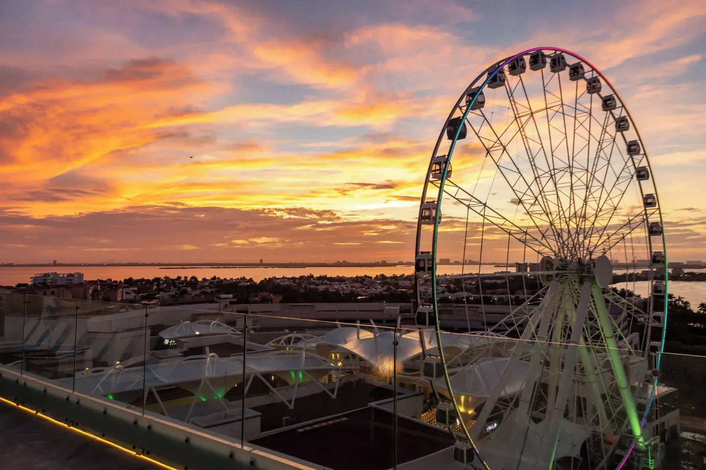 Sunset view of a Ferris wheel near Canopy by Hilton Cancun La Isla.