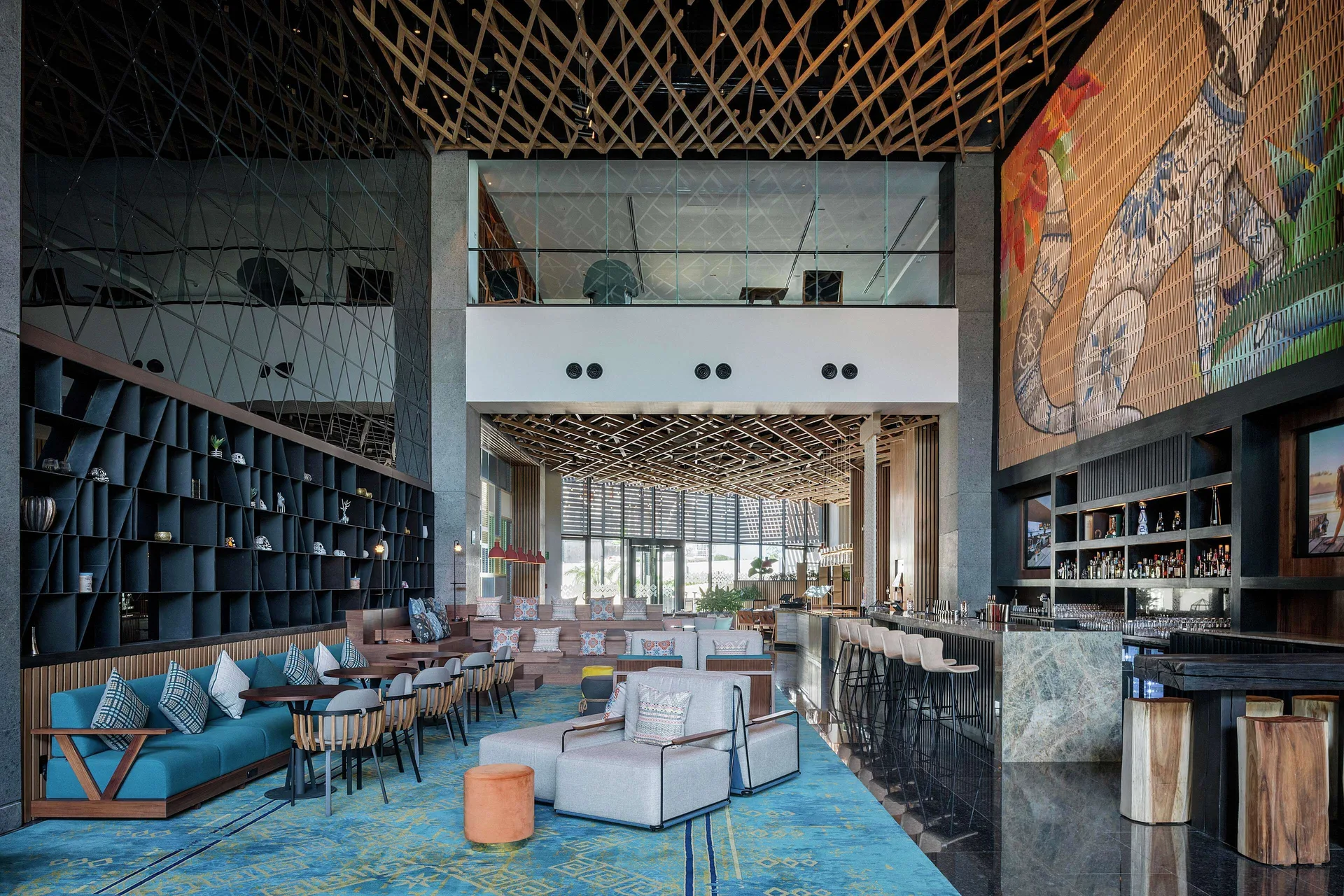 Lounge and bar with tall ceilings at Canopy by Hilton Cancun La Isla.