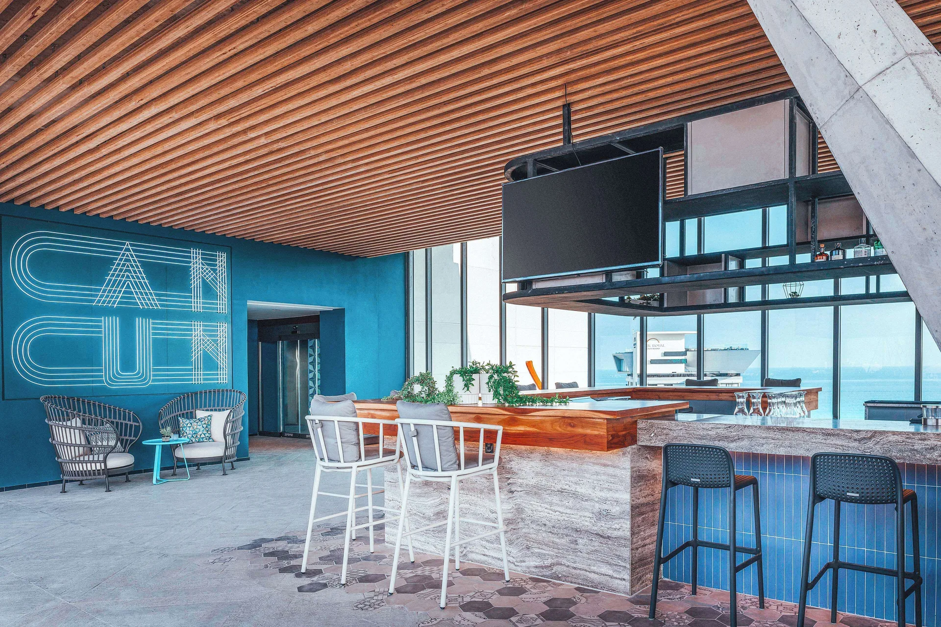 Bright rooftop bar with counter seating at Canopy by Hilton Cancun La Isla.