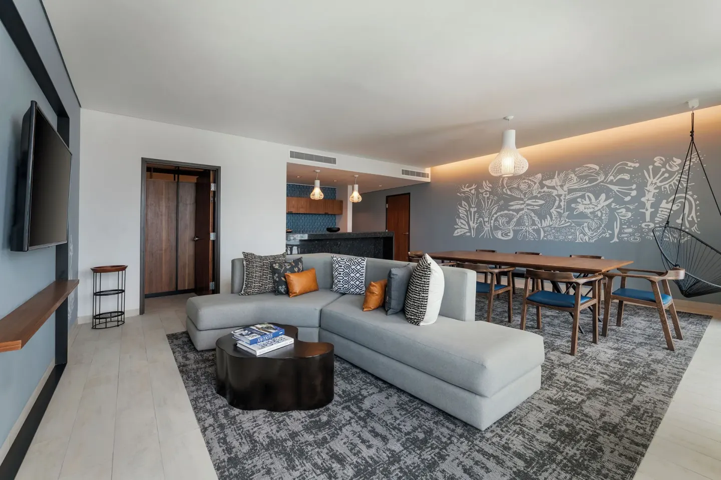 Presidential Suite lounge with sectional sofa and dining table at Canopy by Hilton Cancun La Isla.