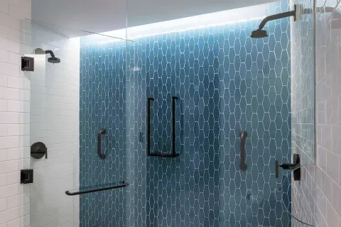 Roll-in shower with grab bars in an accessible room at Canopy by Hilton Cancun La Isla.