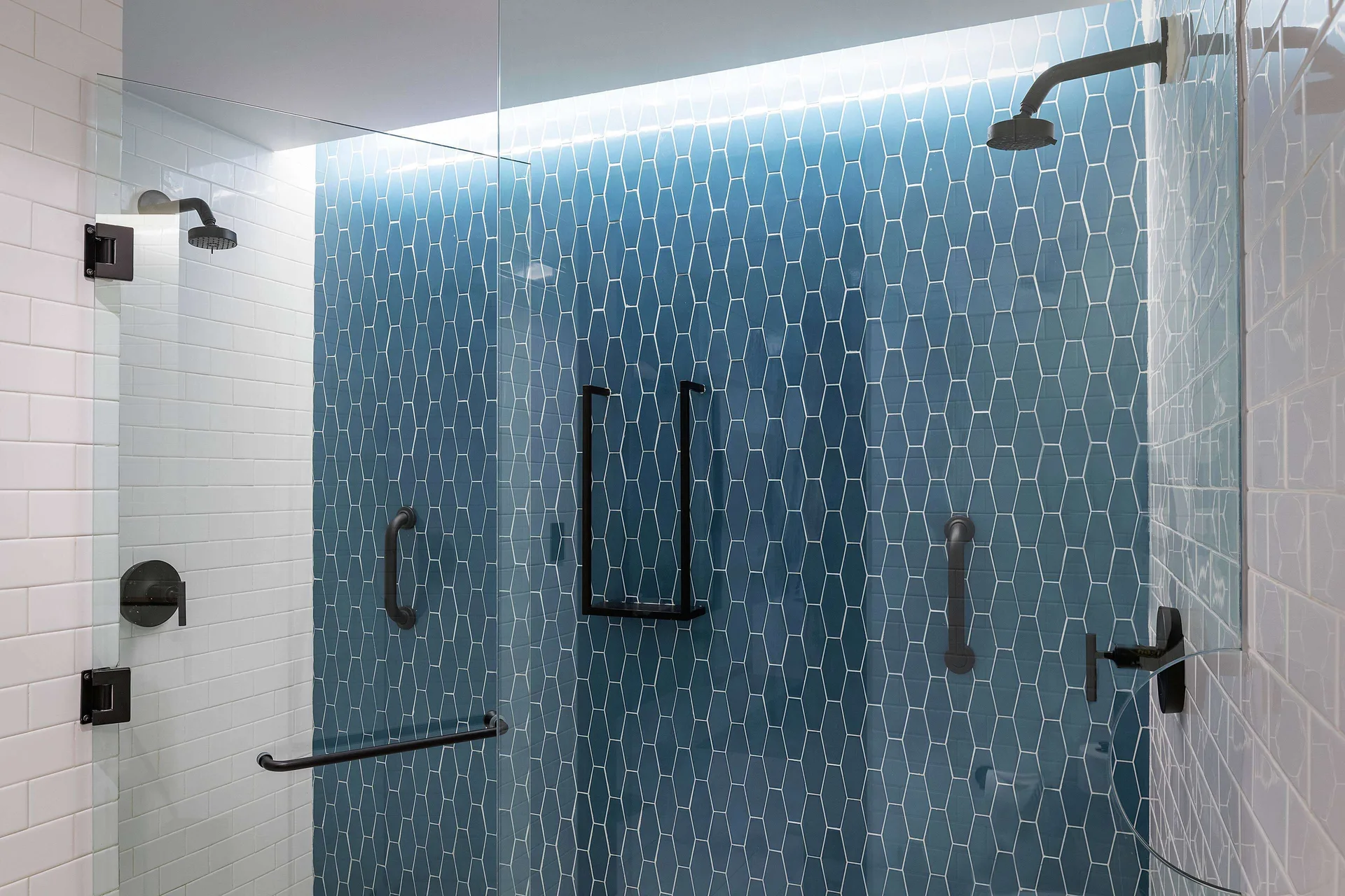 Roll-in shower with grab bars in an accessible room at Canopy by Hilton Cancun La Isla.