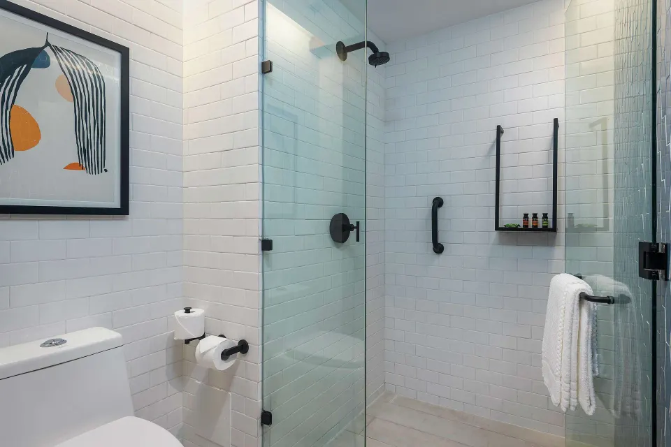 Signature Room bathroom with glass shower at Canopy by Hilton Cancun La Isla.