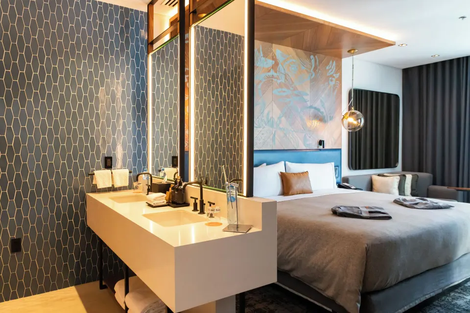 Signature Room king bed and vanity at Canopy by Hilton Cancun La Isla.
