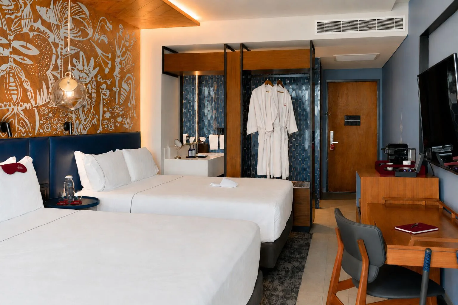Signature Room with two beds and open wardrobe at Canopy by Hilton Cancun La Isla.