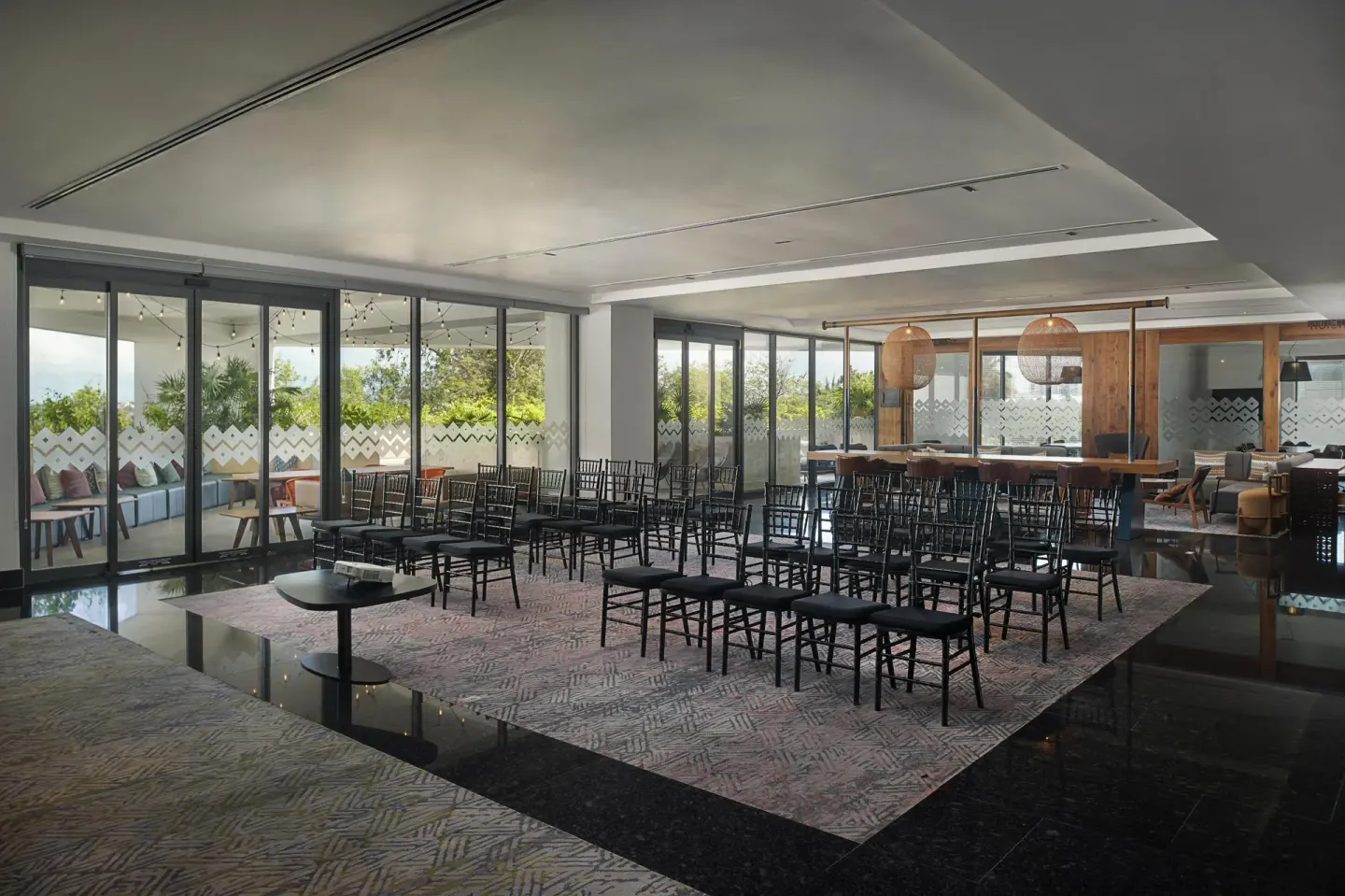 Event space with theater seating and terrace doors at Canopy by Hilton Cancun La Isla.