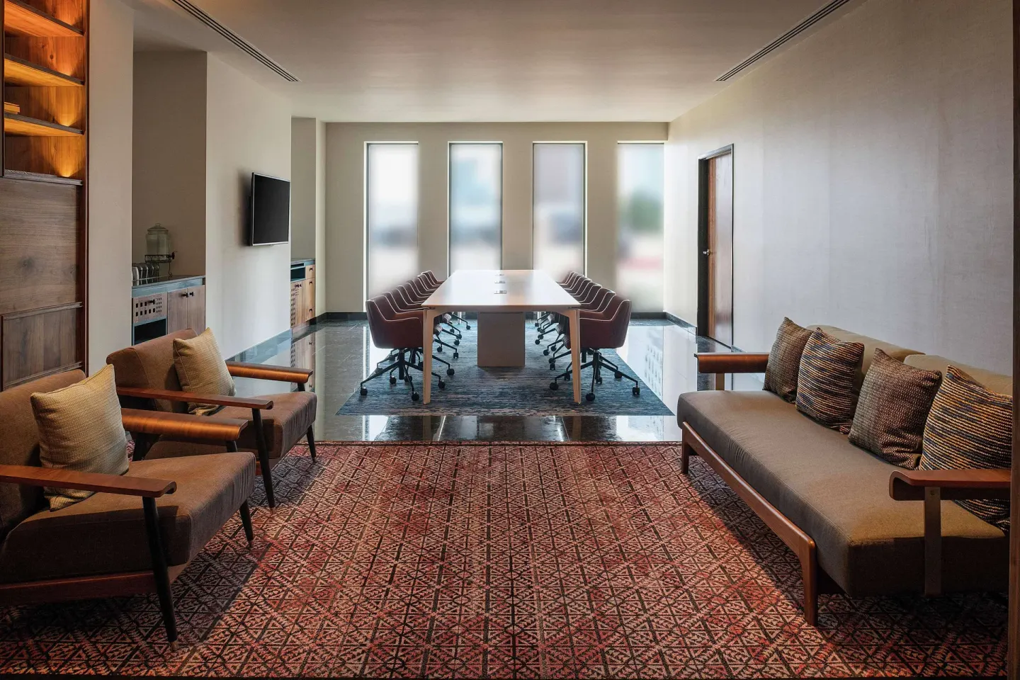 Meeting room lounge and boardroom table at Canopy by Hilton Cancun La Isla.